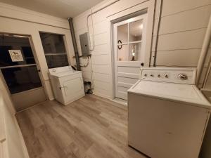 a kitchen with a stove and a washer and dryer at Room Near Downtown UofL,Airport&ExpoCenter in Louisville