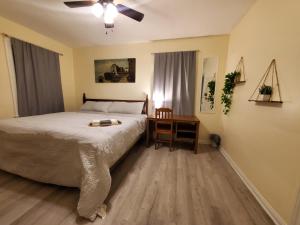 a bedroom with a bed and a desk with a table at Room Near Downtown UofL,Airport&ExpoCenter in Louisville