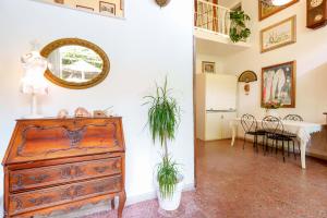 a room with a dresser and a dining room at Villabeachcity Guesthouse in Cagliari
