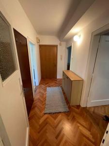 um quarto vazio com um corredor com piso de madeira em Spacious Apartment - green & peaceful em Liubliana