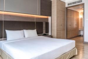 Postel nebo postele na pokoji v ubytování Jasmine City Hotel