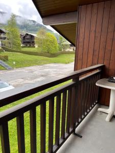 a balcony with a table and a view of a house at Studio avec balcon amenage a Praz sur Arly in Praz-sur-Arly