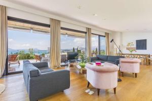 a living room filled with furniture and a large window at Villas Boquer deluxe in Port de Pollensa