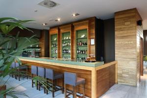 a bar in a restaurant with some chairs and bottles at Precise Resort El Rompido-The Hotel in El Rompido