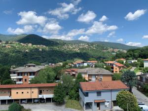 a town with houses and mountains in the background at Appartamenti La Chiocciola Como - Lipomo in Como