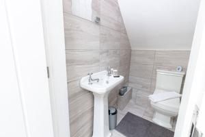a bathroom with a sink and a toilet at Elegant 1BR Apartment, Sleeps up to 4 in Childwall