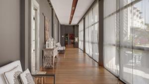 a hallway of a building with glass doors and a hallwayngth at Precise Resort El Rompido-The Hotel in El Rompido