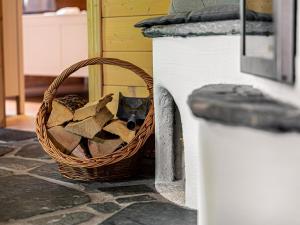 a basket of wood sitting next to a counter at Alpin-Hütten auf der Turracherhöhe - Haus Fuchs by S4Y in Turracher Hohe