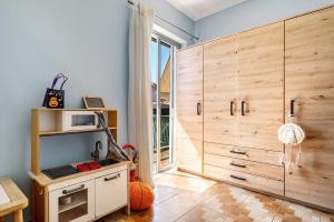 a childs room with a large wooden cabinet at Nice central family apartment in Gastoúni
