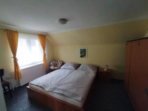 a bedroom with a large bed with a window at Apartmán se zahradou in Krnov