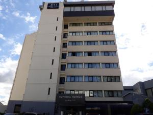 a tall white building with a sign on it at Hotel Eurosol Leiria & Jardim in Leiria