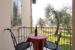 een fles wijn op een tafel op een balkon bij CASA LOMBARDI in Malcesine
