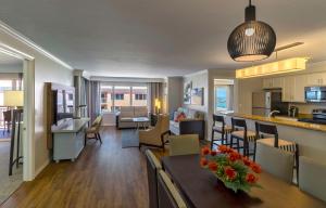 a living room and a kitchen with a table and chairs at Hyatt Regency Clearwater Beach Resort & Spa in Clearwater Beach