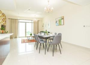 a kitchen and dining room with a table and chairs at RH- Escape to Golf View, 03BR with large Terrace, Greens in Dubai