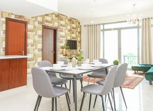 a dining room with a table and chairs at RH- Escape to Golf View, 03BR with large Terrace, Greens in Dubai