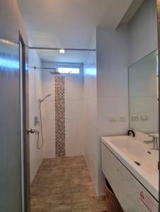 a bathroom with a tub and a sink and a shower at Grandblue condominium 301 in Ban Tha Fat