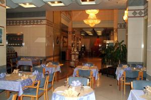 a dining room with blue tables and chairs at Spark Residence Hotel in Sharjah
