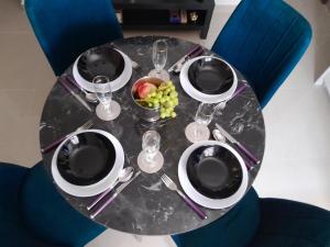 a table with plates and wine glasses and a bowl of fruit at Gama LUX in Perea