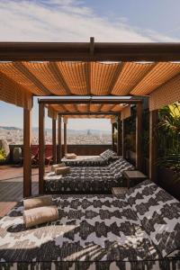 two beds on a roof with a view of the city at Nobu Hotel Barcelona in Barcelona