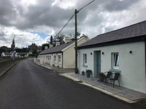 an empty street with buildings on the side of the road at 3 Quay Cottage Killala. Luxury Sea-Front Cottage in Killala
