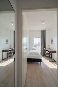 a bedroom with a bed and a table and chairs at Norden Homes 2-Bedroom Apartment in Turku