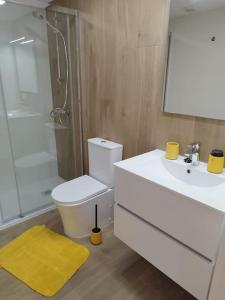 a bathroom with a toilet and a sink and a shower at Cullera Mar in Cullera