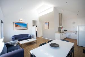 a living room with a couch and a table at Clearwater Motel Apartments in Esperance