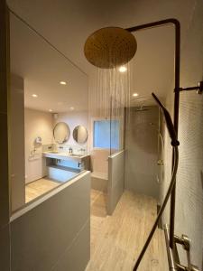 a bathroom with a shower and a sink and a mirror at Hotel Riva Beach in Porto-Vecchio