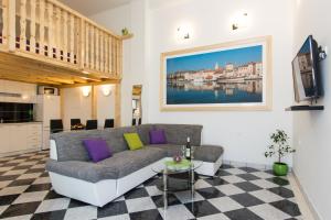 a living room with a couch and a table at Apartments Storia in Trogir