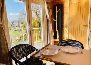 a table and chairs with a view of a window at Cwt y Bugail in Barmouth