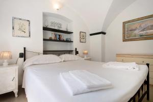 a bedroom with a white bed with two towels on it at Oceane Paradise - Luigi 14 in Levanto