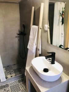 a bathroom with a sink and a shower at Solo traveler in Ermoupoli