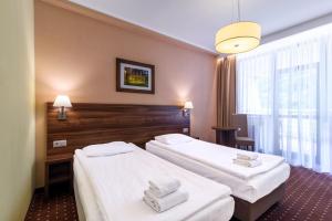 Postel nebo postele na pokoji v ubytování Hotel Podium