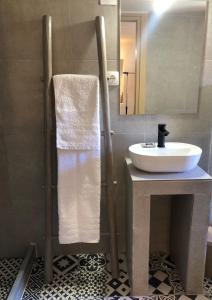 a bathroom with a sink and a mirror at Solo traveler in Ermoupoli
