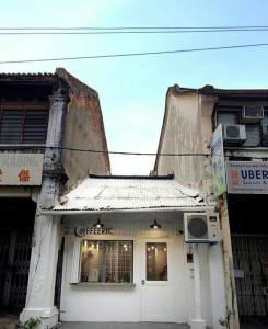 an old white building with a sign on it at Apartment in Rizal short stay only in Teresa