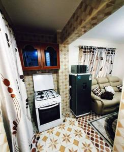 a kitchen with a stove and a couch at Apartment in Rizal short stay only in Teresa