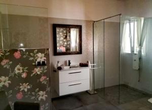 a bathroom with a sink and a glass shower at El Patio de San Bernardo in Seville