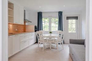 a kitchen and dining room with a table and chairs at Duinzand in Zandvoort