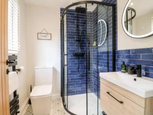 a bathroom with a shower and a sink at Minster Cottage - Cathedral Quarter with Permit Parking in Lincoln
