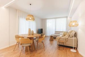 a living room with a table and chairs and a couch at Bravissimo Devesa, 3 bedrooms and near the parc in Girona