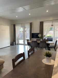 a living room with a table and chairs at Apartamenti Starp Krastiem 2 in Liepāja +15 photos