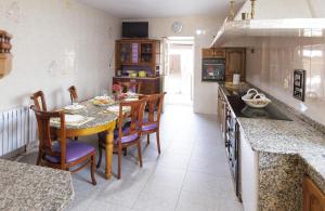 a kitchen with a table and some chairs and a counter at A Casa De Lucha in Meis
