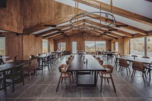 a dining room with tables and chairs and a chandelier at Highland Base Kerlingarfjöll in Kerlingarfjoll