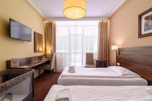 Postel nebo postele na pokoji v ubytování Hotel Podium
