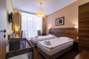 Postel nebo postele na pokoji v ubytování Hotel Podium