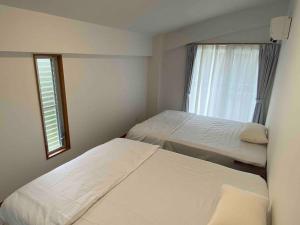 Voodi või voodid majutusasutuse 貸切別荘カリイ Vacation Rental KALLY Naha Okinawa toas
