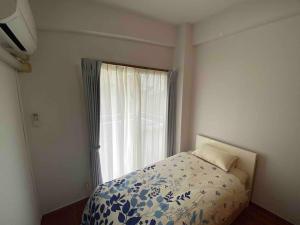 Voodi või voodid majutusasutuse 貸切別荘カリイ Vacation Rental KALLY Naha Okinawa toas