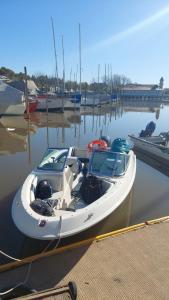 a white boat is docked at a dock at OBLIGADO ESTUDIO SAN PEDRO in San Pedro