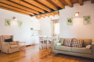 a living room with a couch and a table at Residenze Di La' Dal Fiume in Caorle