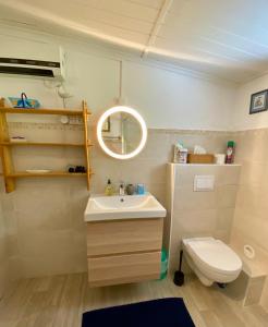 a bathroom with a white sink and a toilet at Maisonnette à Portissol, plages et Port à pieds! in Sanary-sur-Mer